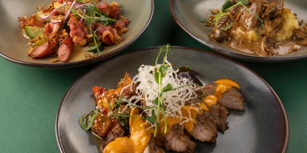 Three plated gourmet dishes with meat and vegetables.