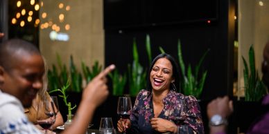 People laughing and enjoying drinks together.