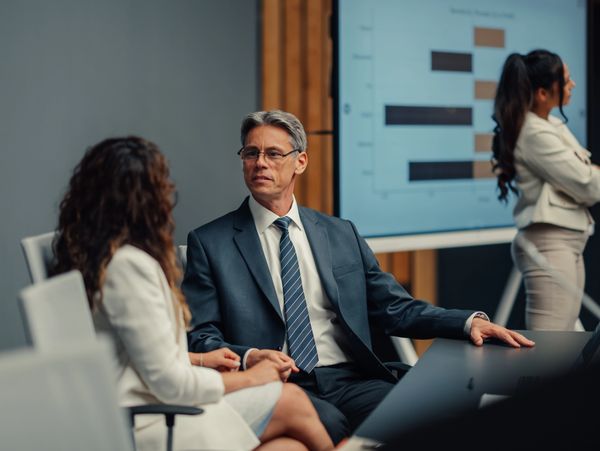 Business meeting with people discussing data.