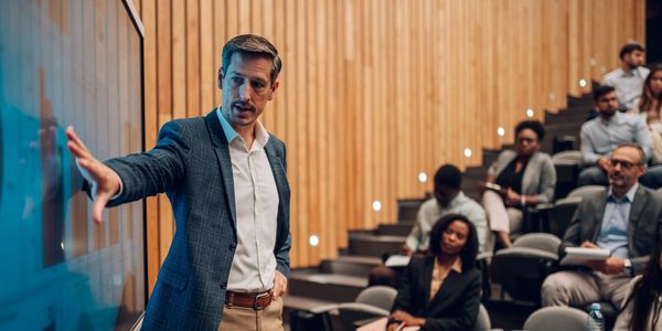 A man giving a presentation in a lecture hall.