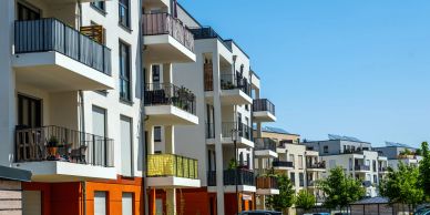 Modern apartment buildings with balconies under a clear sky.