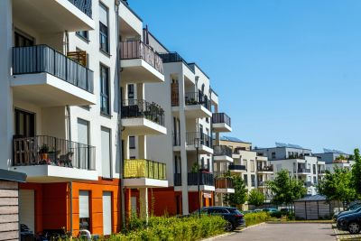 Modern apartment buildings under a clear blue sky.