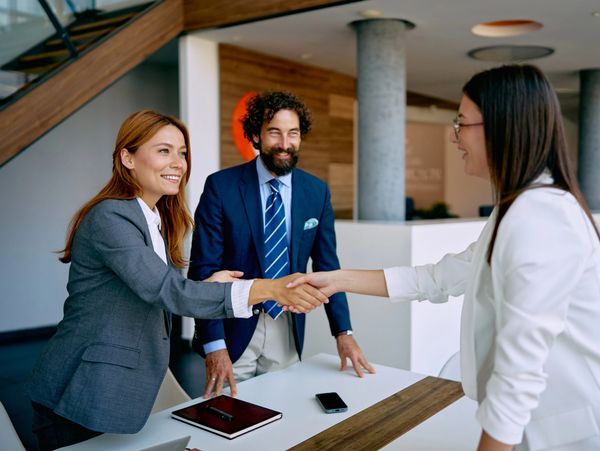 Business people shaking hands in an office.