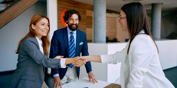 Business people shaking hands in an office.