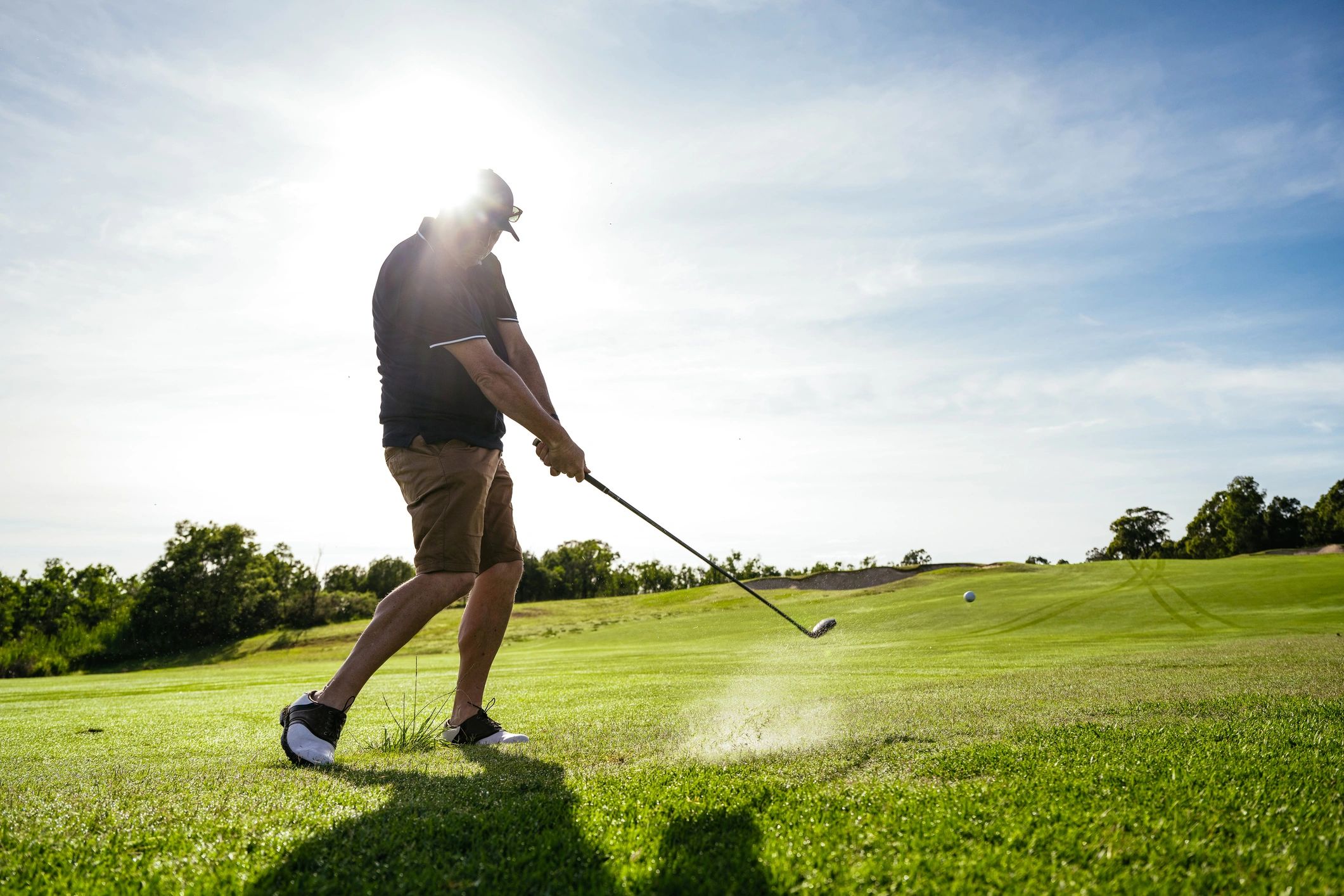 Golfer teeing off at Rum Creek Golf's par-3 course in Stockbridge, GA
