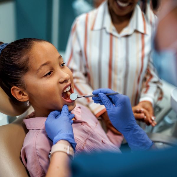 A patient getting dental cleaning in a clinic.