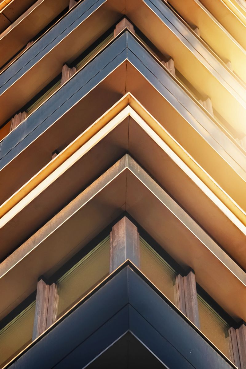 The image highlights the sharp angles and modern design elements of a contemporary building during sunset.