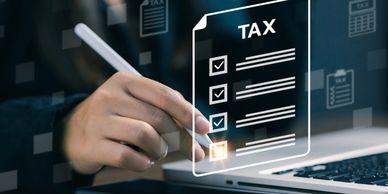 This image shows someone at a computer working on a tax checklist.