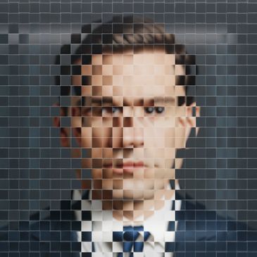 Pixelated portrait of a man in a suit and tie.