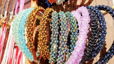 Colorful beaded bracelets arranged on a wooden surface.