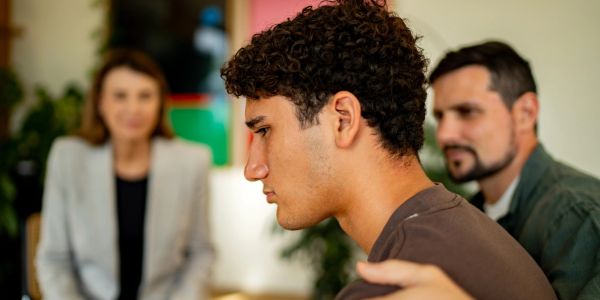 Young man being supported during a counseling session.