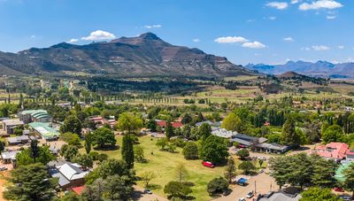 Scenic view of a town with mountains in the background.