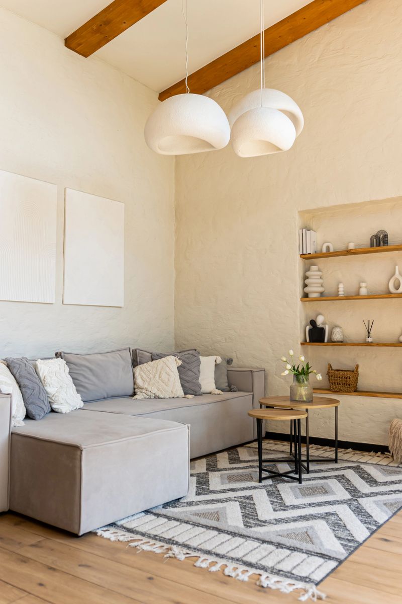 Modern living room interior with cozy sofa and wooden shelves in minimalist home space