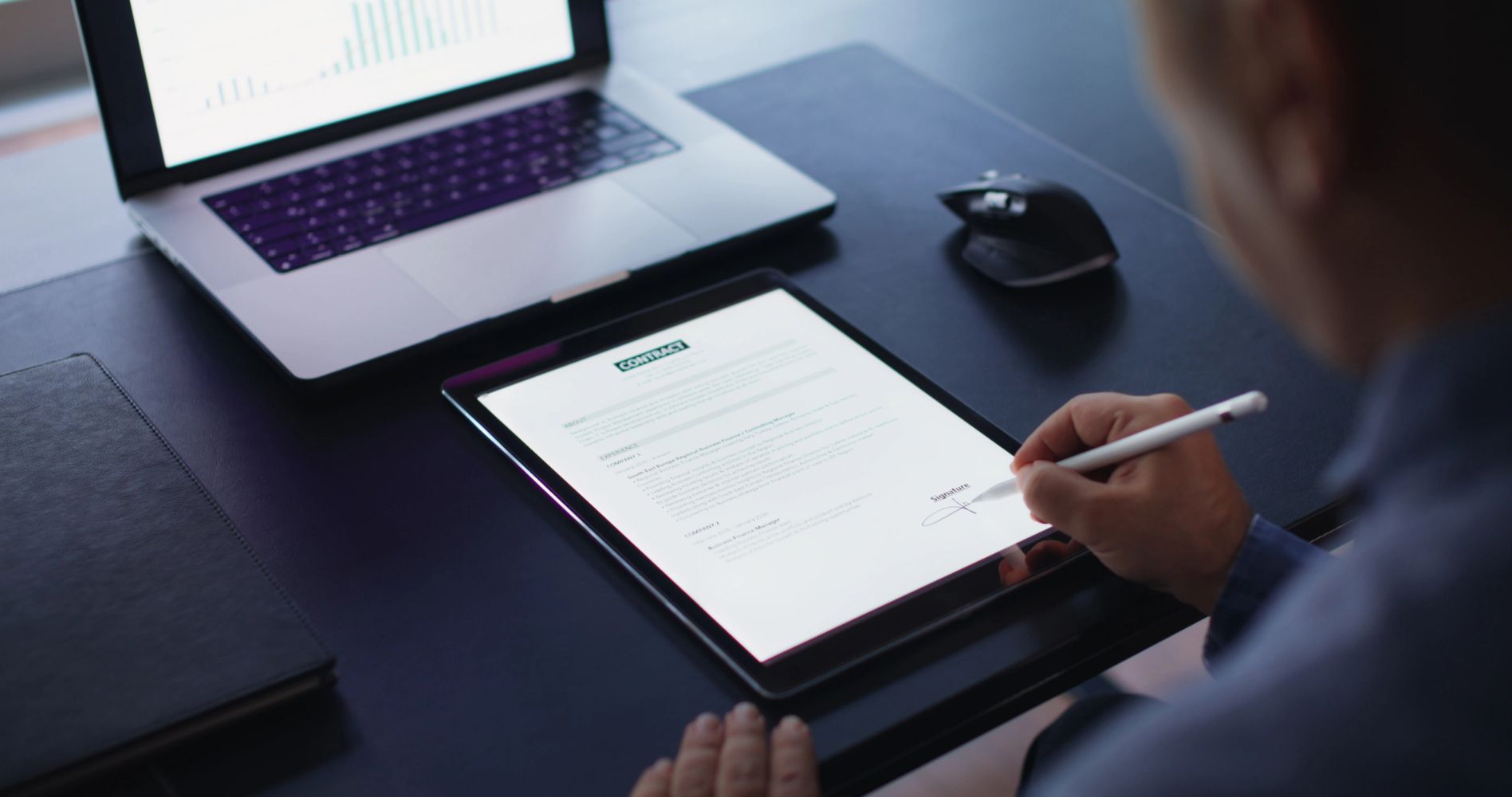 Person using a stylus on a tablet device.