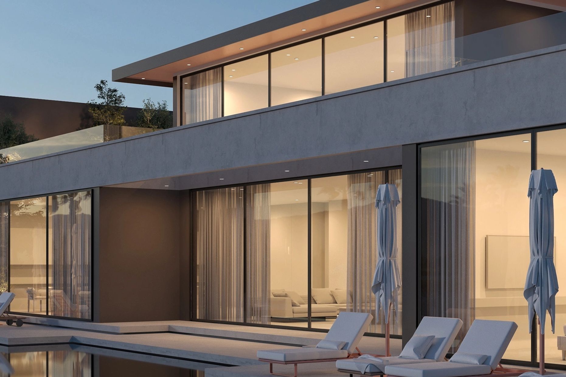 Modern house with large glass windows and outdoor lounge chairs by the pool.