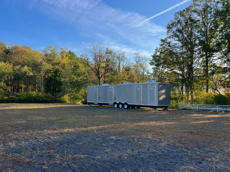 Portable restroom trailer in public parked used for events.