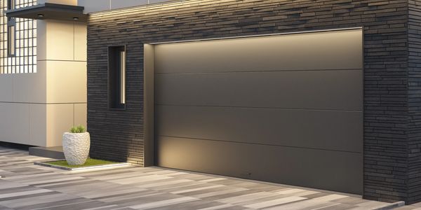 Modern garage door with dark paneling and subtle lighting.