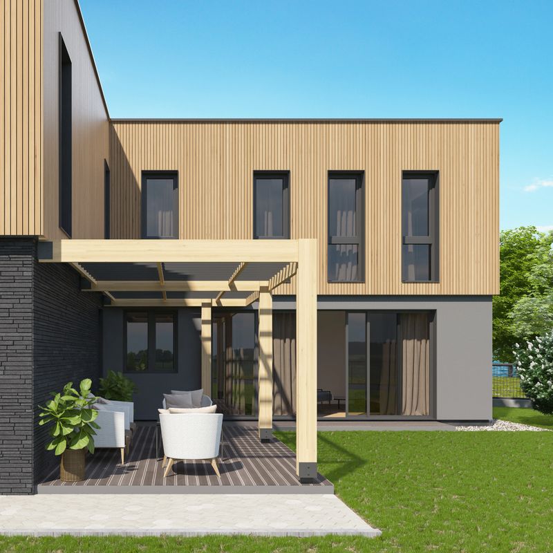 Modern Scandinavian house with a cozy outdoor patio covered by a light wood pergola, featuring white and gray lounge furniture, potted plants, and large glass sliding doors that connect the space to the interior. The clean lines, natural materials, and open layout create a calm and stylish atmosphere, ideal for relaxing, entertaining guests, or showcasing outdoor living. Surrounded by greenery and trees, the setting offers a peaceful suburban vibe. This image is suitable for real estate ads, home design blogs, architecture portfolios, lifestyle articles, or promotional materials focused on patio inspiration and modern exterior design.