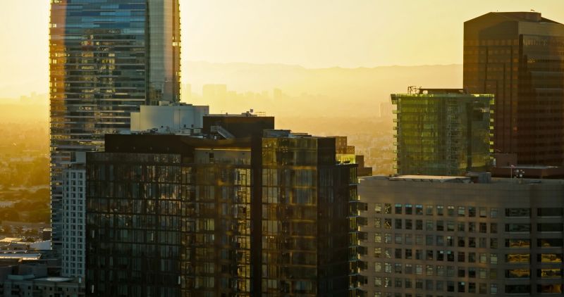 Aerial shot of the Downtown District overlooking the cityscape of Los Angeles at sunset.