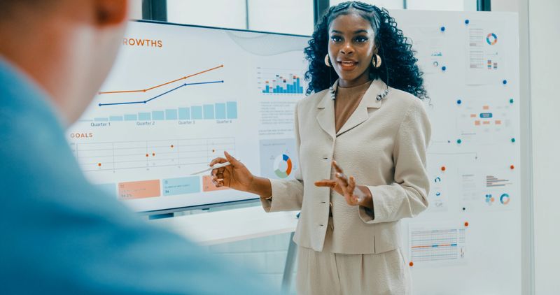Diverse finance team business meeting leader presenting investment strategy and budget planning at modern office. Marketing strategy analysis, stock market trading, financial consultant concept.
