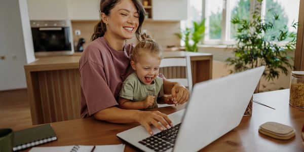 Mother and child enjoying laptop time together.