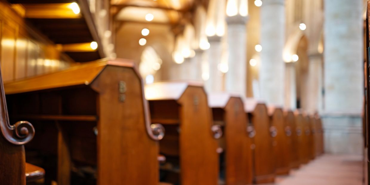 Row of wooden pews inside a church.