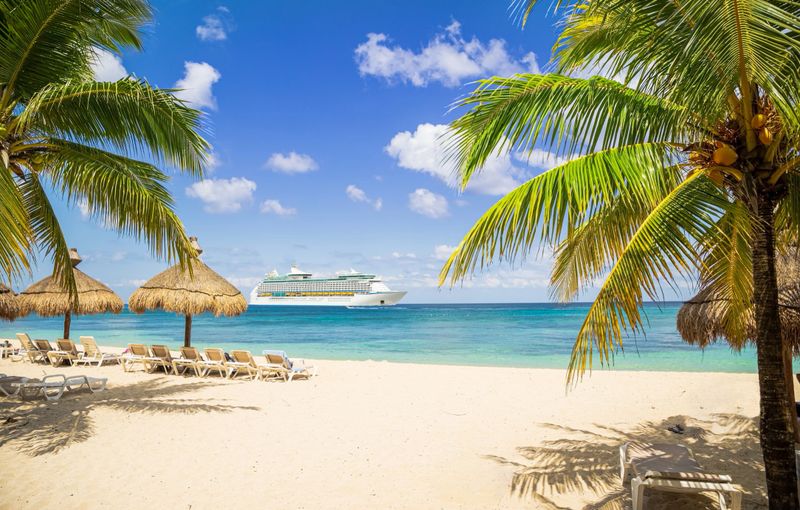View from tropical beach on cruise ship sailing from port