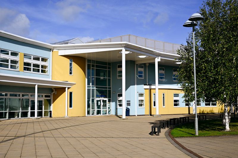 Secondary comprehensive school with empty benches and footpath