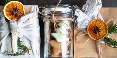 Christmas gift wrapping with rustic decorations and cookies.
