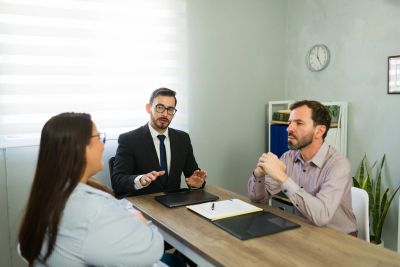 Three people having a business meeting in an office.