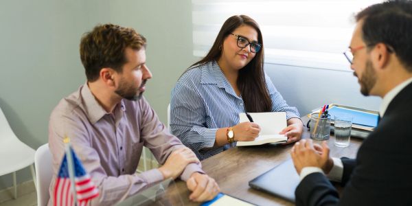 Three individuals having a business meeting.