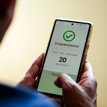 Person holding phone displaying earned points.