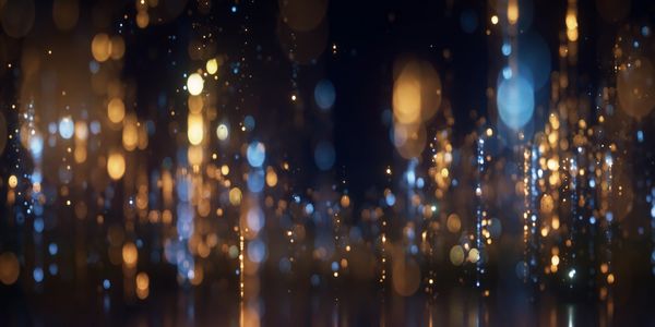 Abstract bokeh lights in blue and gold tones.