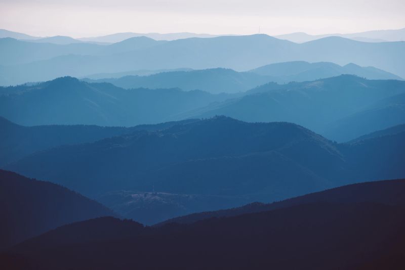 Carpathian mountains summer sunset landscape with abstract gradient of mountain peaks in blue colors, natural travel outdoor background