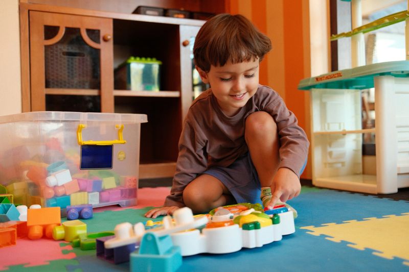 Smiling child playing with colorful toys during a fun photography session
