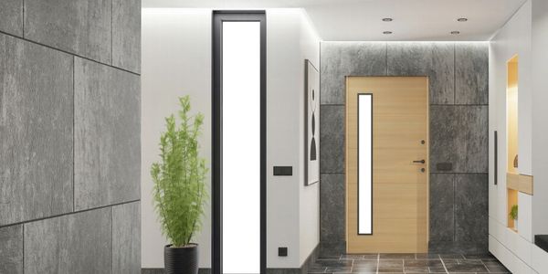 Modern entryway with wooden door and tall window beside a potted plant.