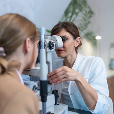 Smiling female optometrist examining a patient