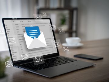 Laptop showing incoming email notifications.