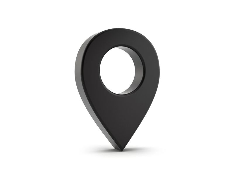 Black map pin on white background with soft shadows