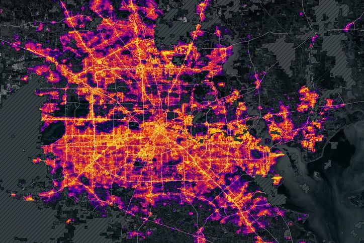 Houston at night, depicted as a vibrant heatmap with glowing orange and purple lights. This visual vividly illustrates urban activity, highlighting population density and dynamic traffic flow, with image elements furnished by NASA data.