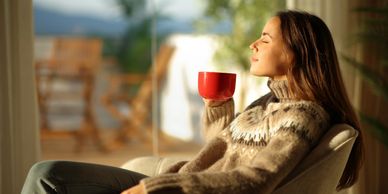 Woman relaxing calmly with a warm drink, representing everyday ways to manage anxiety