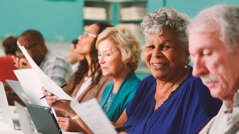 Group Of Retired Seniors Attending IT Class In Community Centre