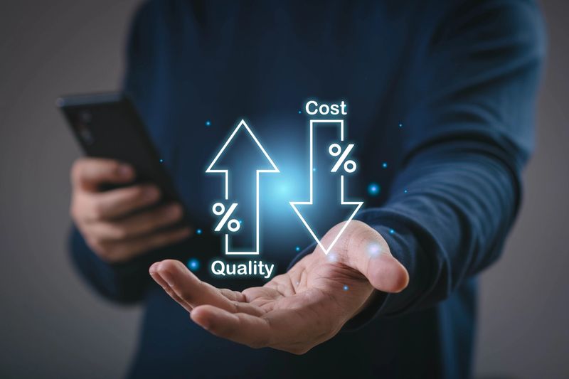 Businessman holding digital icons of increasing quality and decreasing cost, concept of business efficiency, cost reduction, productivity, financial management, and strategic improvement for success.