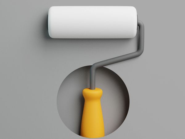 Close-up of a paint roller with a yellow handle on a gray background.