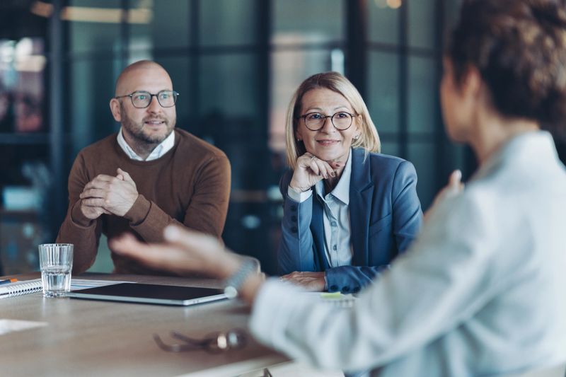 Three business persons talking in the office