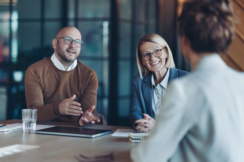 Three business persons talking in the office