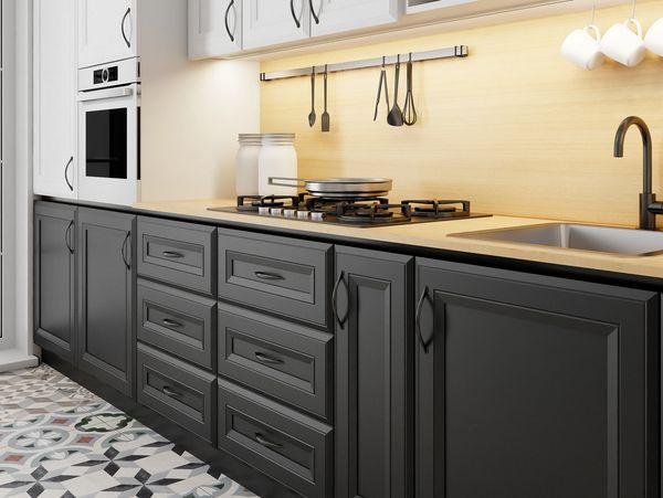 Modern kitchen with black lower cabinets and patterned tile floor.
