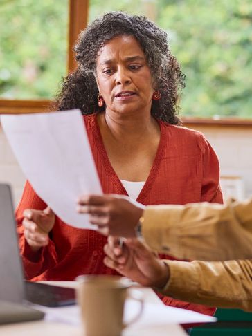 Woman reviewing a document with another person.