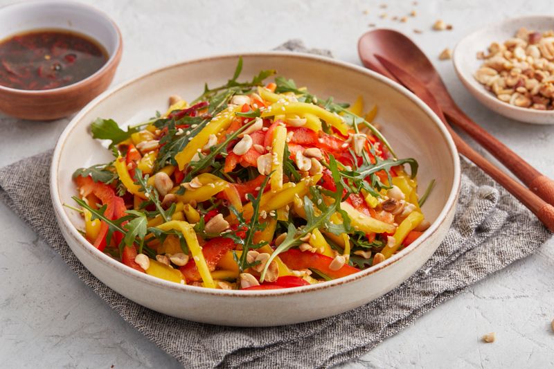 A colorful Thai salad with fresh mango, vegetables, and creamy peanut dressing — vibrant, tangy, and full of tropical flavor. A perfect vegan summer dish for lunch or dinner.