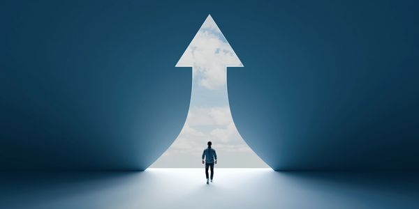 A person walks toward an arrow-shaped opening symbolizing direction or progress.